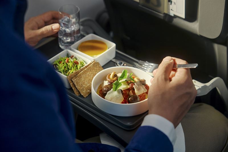 a person eating food on a tray