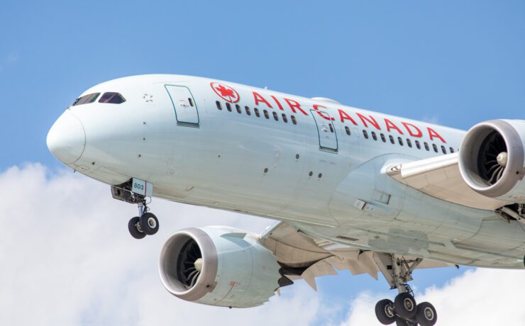 A close up of an Air Canada Boeing 787 Dreamliner flying in the sky
