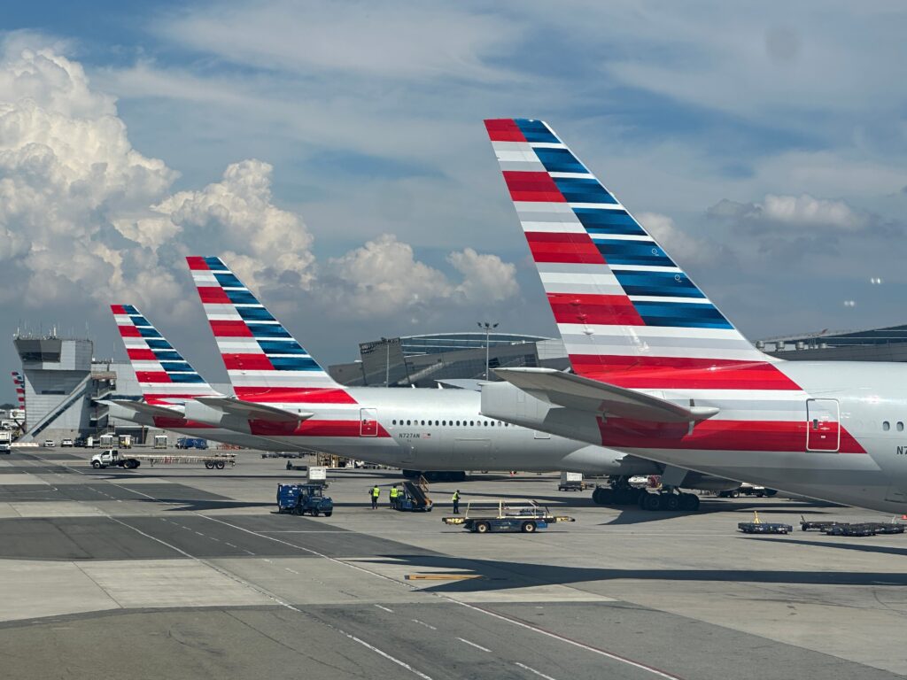 Tails of American Airlines airplanes parked at a gate at the airport