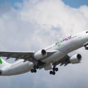 A Wamos Air Airbus A330 flying through clouds