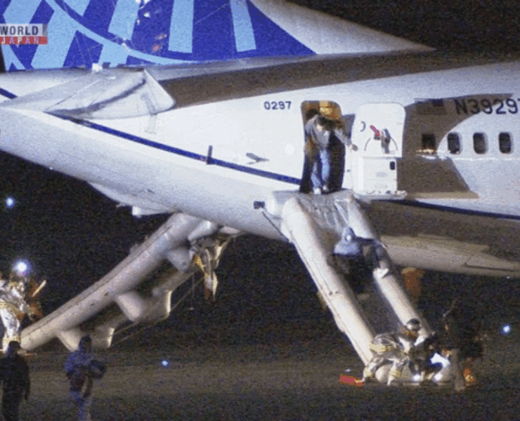 Screenshot of news channel showing passenger using emergency slides to evacuate a United Airlines Boeing 737