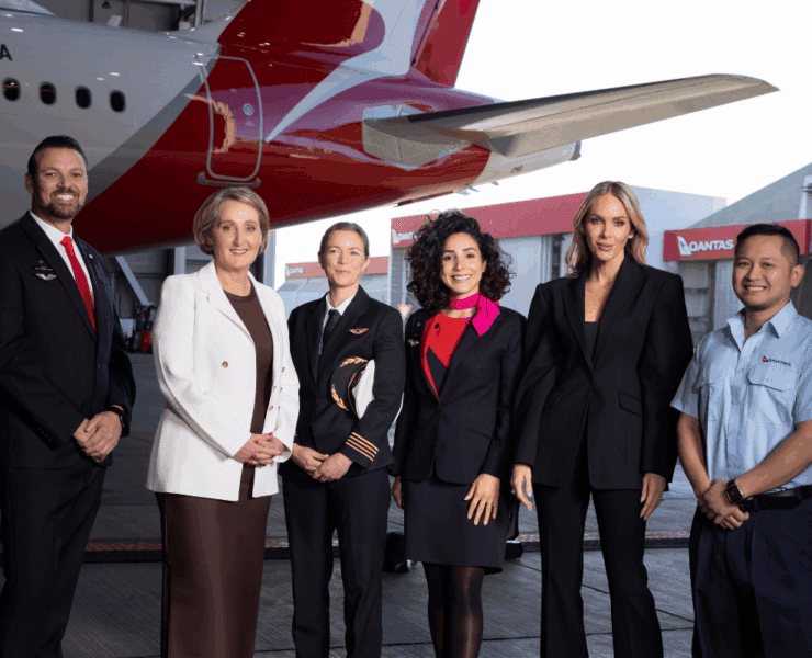 Australian designer Rebecca Vallance stands amongst a group of Qantas employees
