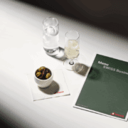 a menu and a bowl of olives