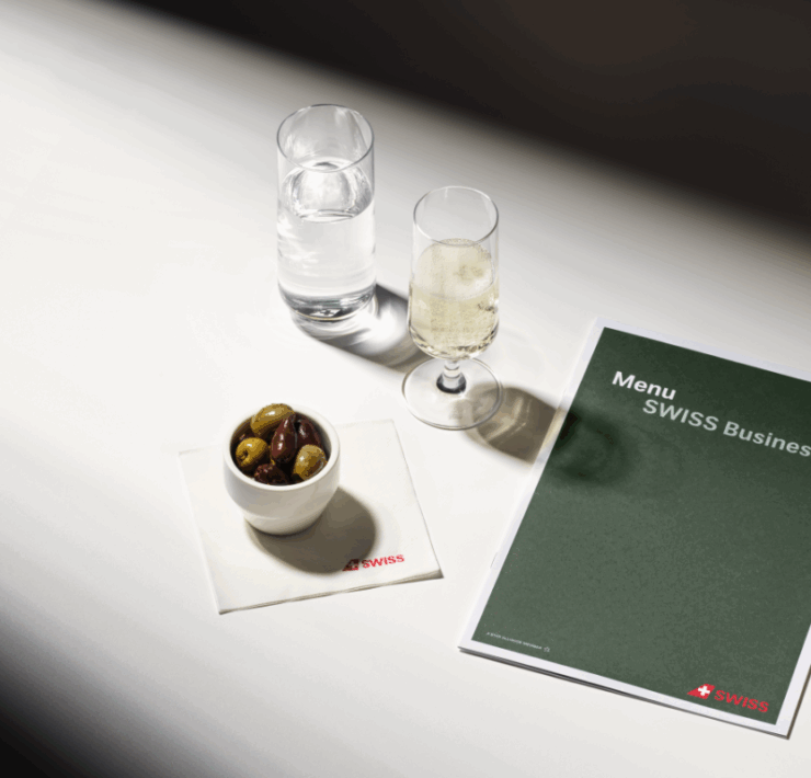 a menu and a bowl of olives