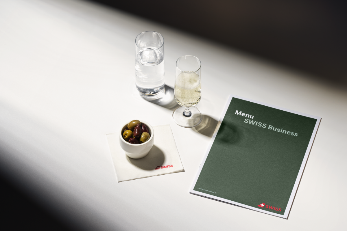 a menu and a bowl of olives