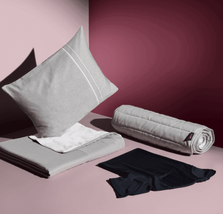 a pillow and a rolled up blanket