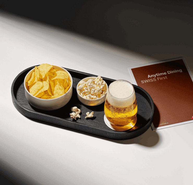 a tray of food and a glass of beer