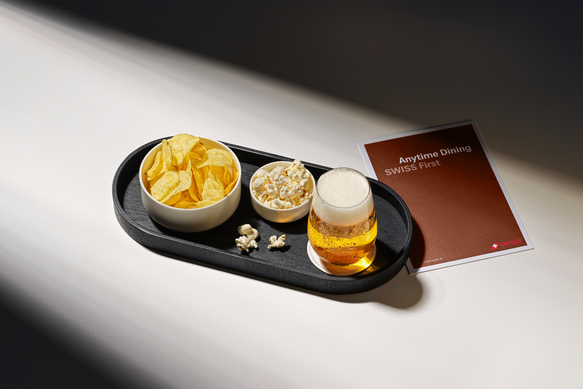 a tray of food and a glass of beer