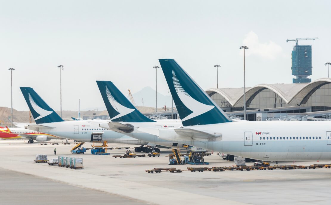 three cathay pacific aircraft parked at the gate at Hong Kong international airport