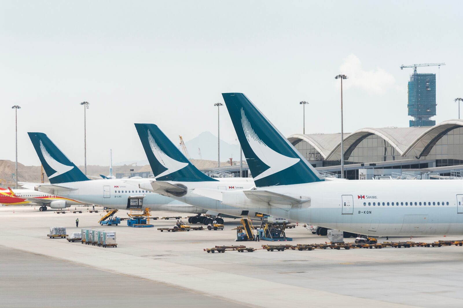 three cathay pacific aircraft parked at the gate at Hong Kong international airport