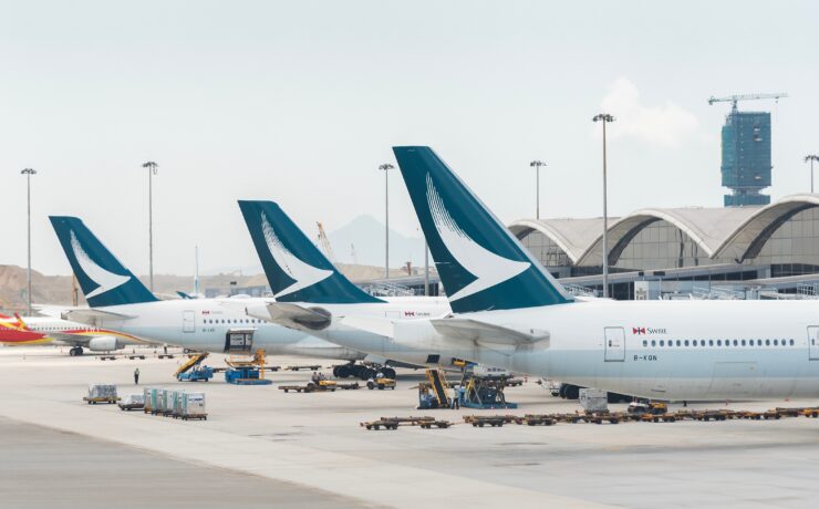three cathay pacific aircraft parked at the gate at Hong Kong international airport