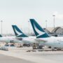 three cathay pacific aircraft parked at the gate at Hong Kong international airport