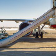 an activated evacuation slide on the side of an aircraft