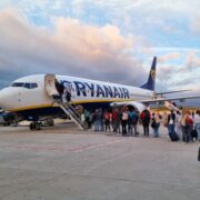 passengers lining up to board a ryanair boeing 737 parked on the apron