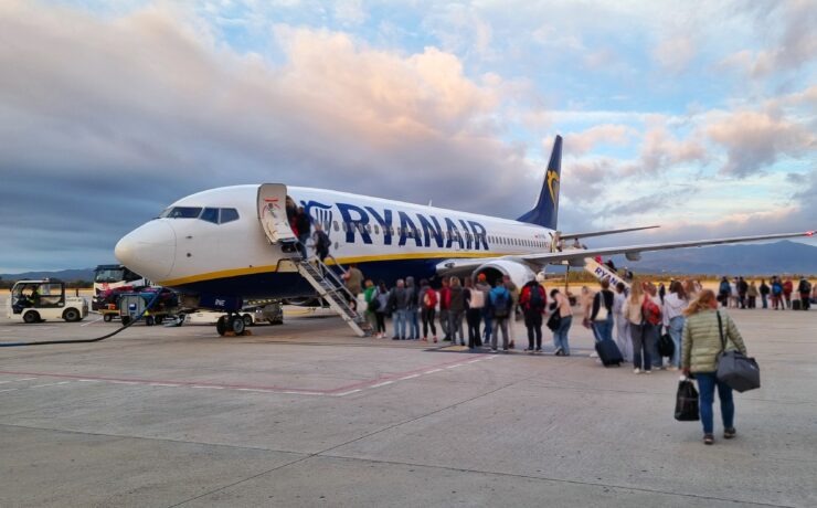 passengers lining up to board a ryanair boeing 737 parked on the apron
