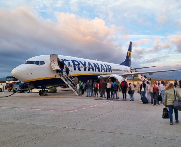 passengers lining up to board a ryanair boeing 737 parked on the apron