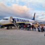 passengers lining up to board a ryanair boeing 737 parked on the apron