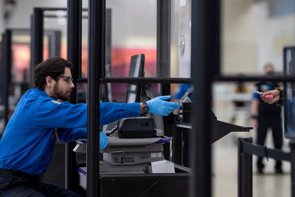 tsa agent behind a screen