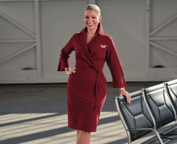 a delta air lines flight attendant wears a new version of the carrier's iconic wrap dress