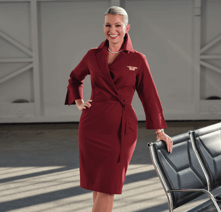a delta air lines flight attendant wears a new version of the carrier's iconic wrap dress
