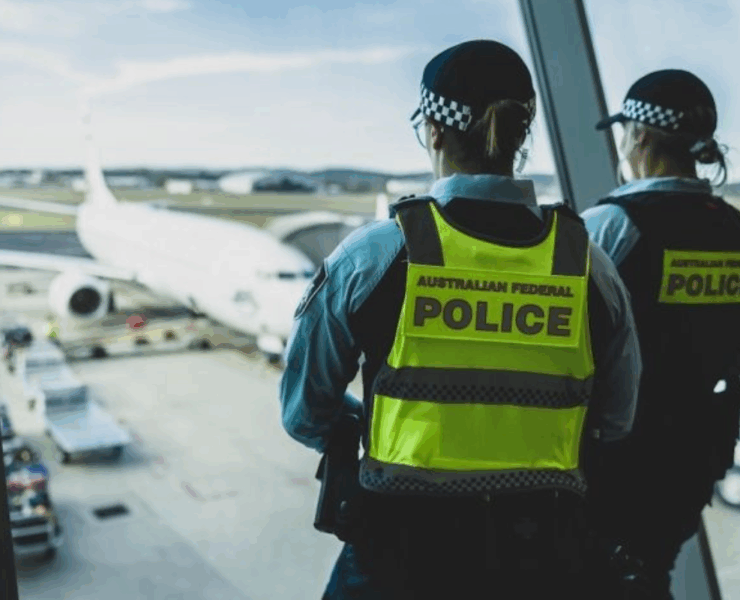 a police officers looking out a window at an airplane