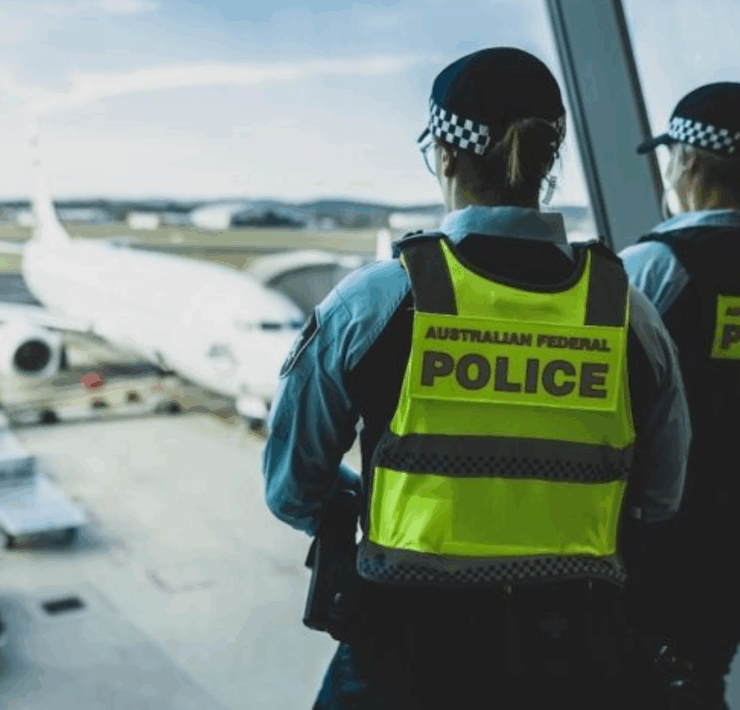 a police officers looking out a window at an airplane