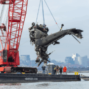 a helicopter being lifted by a crane