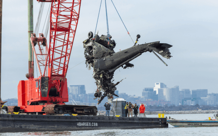 a helicopter being lifted by a crane