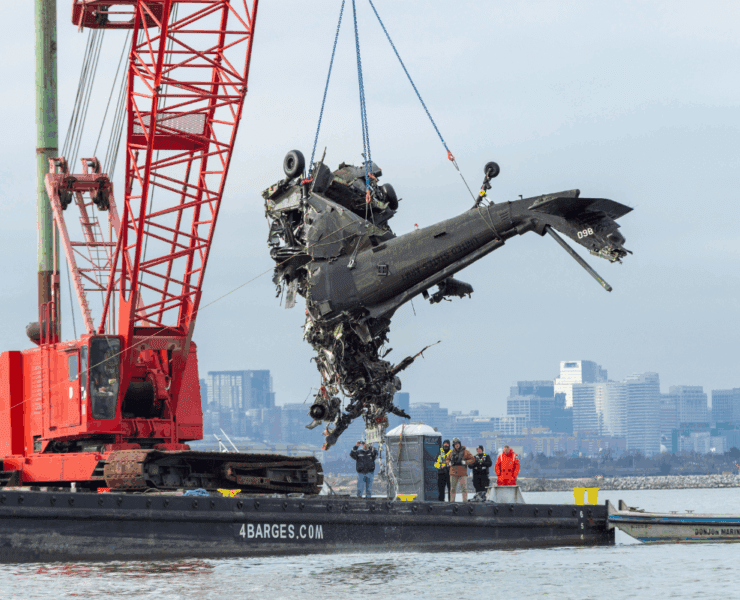 a helicopter being lifted by a crane