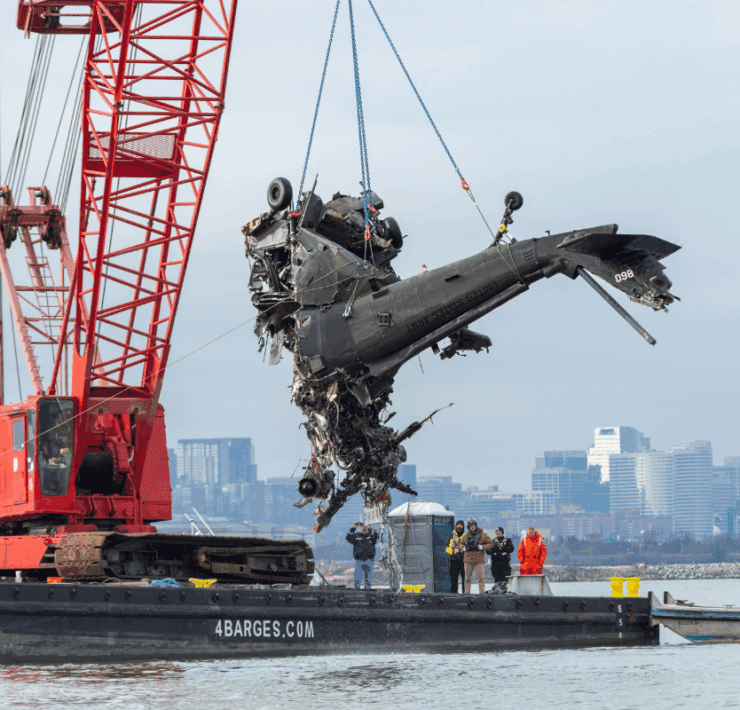 a helicopter being lifted by a crane