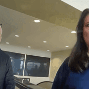 a man and woman standing in a room