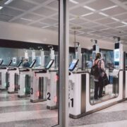 a woman passing through an automated passport gate in Milan