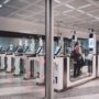 a woman passing through an automated passport gate in Milan