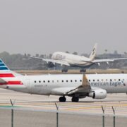 An American Airlines regional jet operated by SkyWest lining up on the runway for takeoff