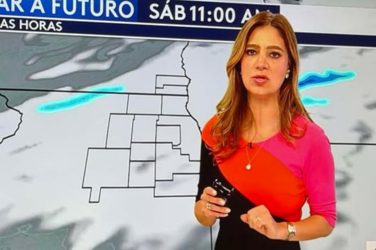 a woman standing in front of a map