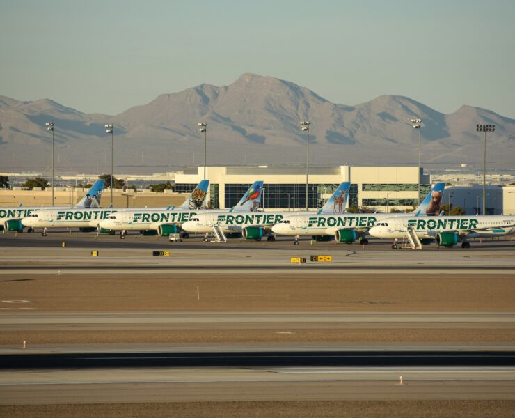 frontier airlines planes parked on the tarmac