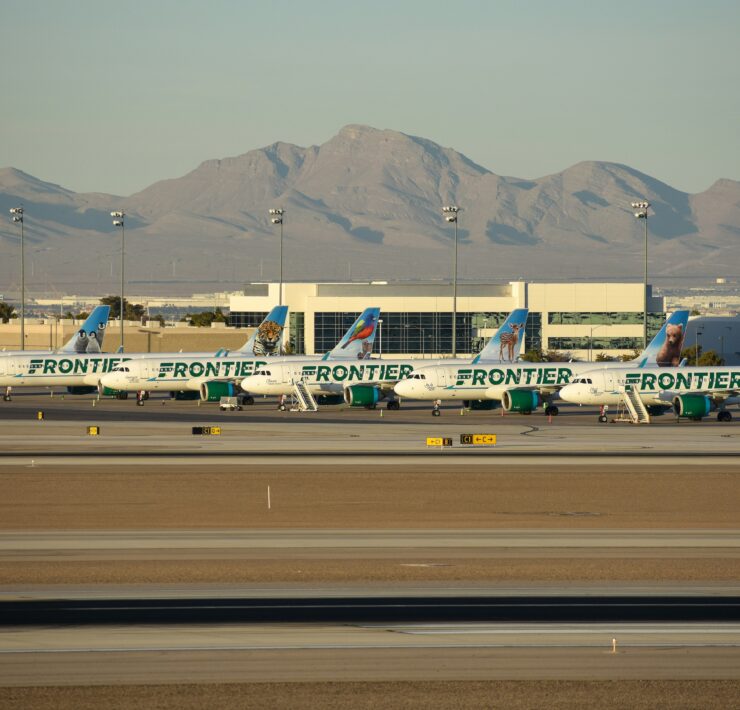 frontier airlines planes parked on the tarmac