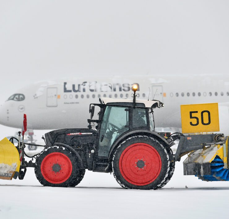 heavy snowfall at munich airport with a lufthansa plane covered in snow