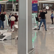a man holding a silver object in front of a group of people