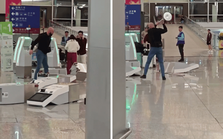 a man holding a silver object in front of a group of people