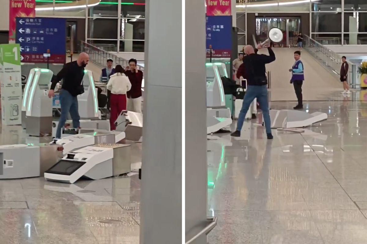 a man holding a silver object in front of a group of people