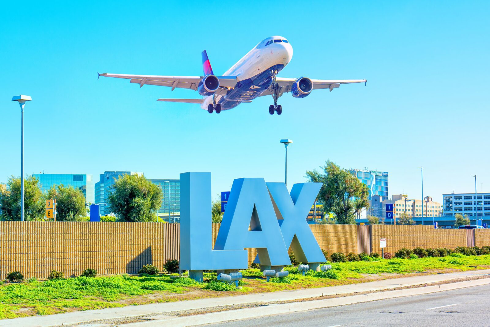 an airplane flying over a sign