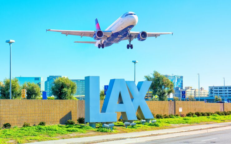 an airplane flying over a sign