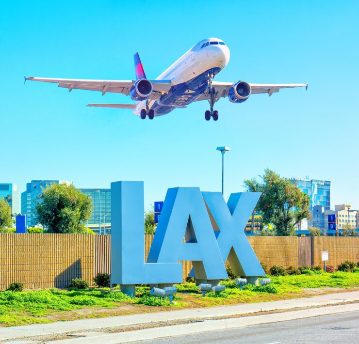 an airplane flying over a sign