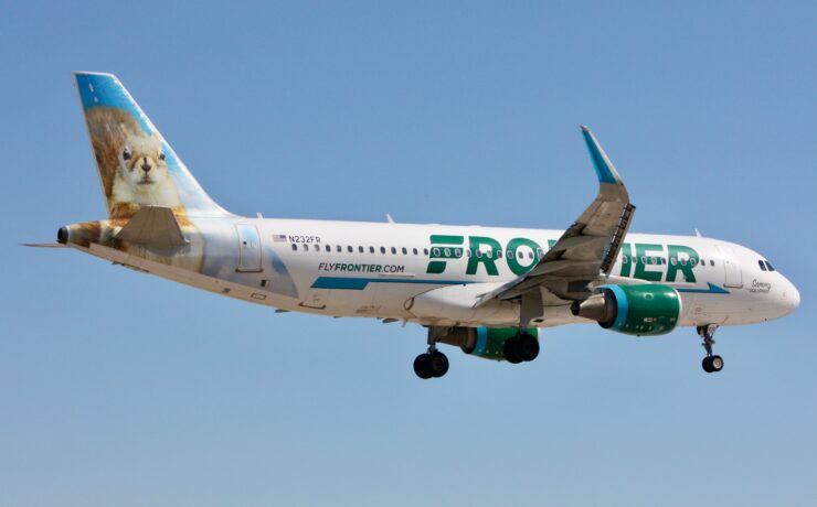 a frontier airlines airbus a320 flying in the sky