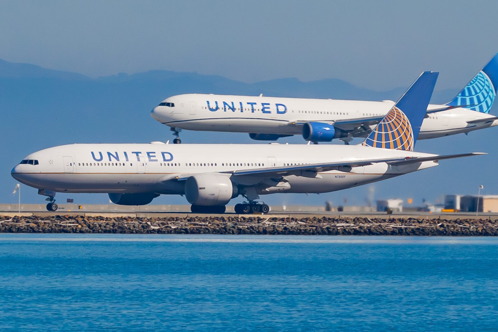 two united airlines planes coming into land at SFO
