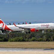an air canada rouge plane coming into land at tampa airport a plane taking off from a runway