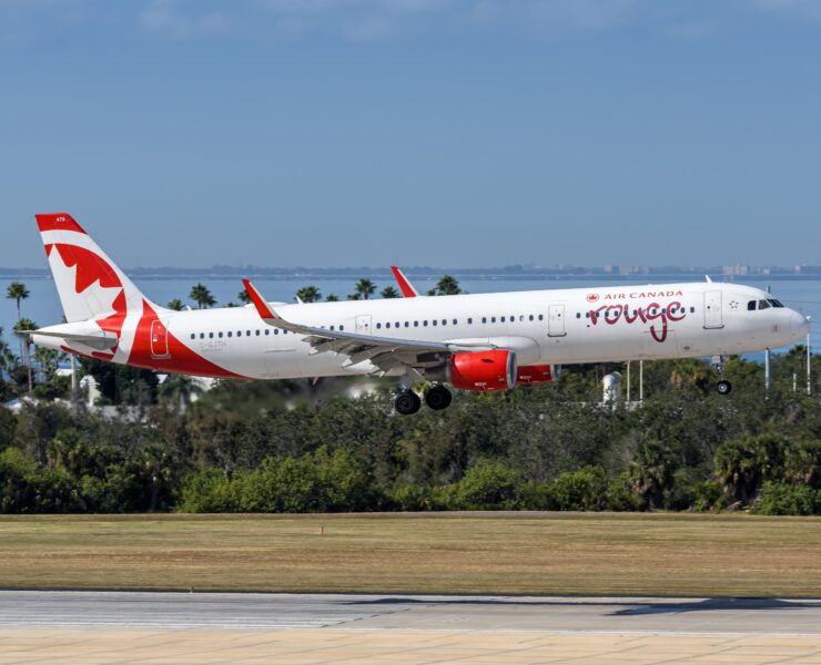 an air canada rouge plane coming into land at tampa airport a plane taking off from a runway