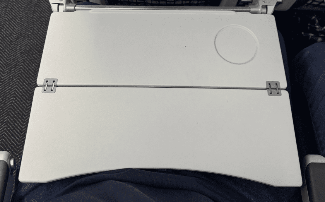 a closr up of a tray table on a united airlines plane