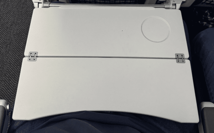 a closr up of a tray table on a united airlines plane